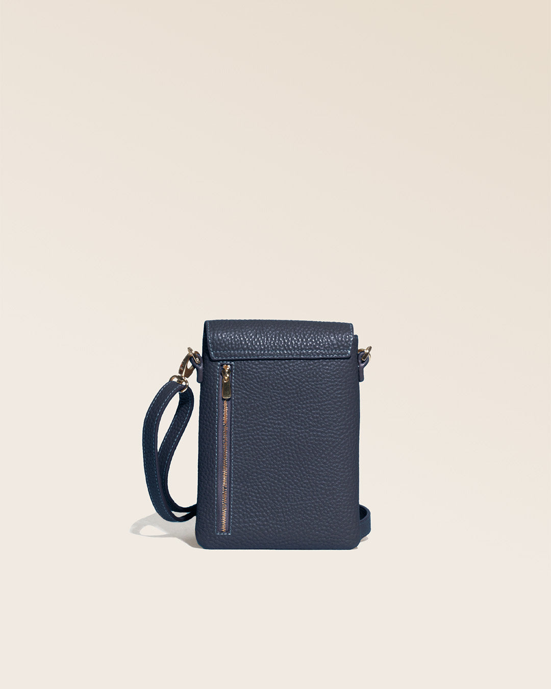 Our seagull clutch bag in navy blue vicuña-style leather, seen from the back in the studio.