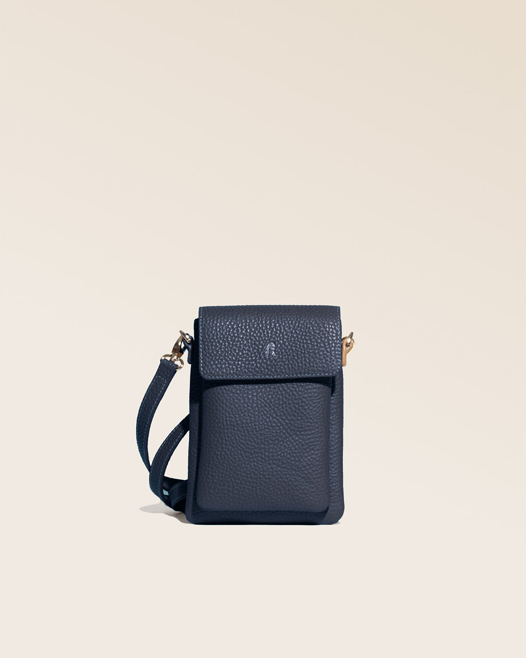 Our seagull clutch bag in navy blue vicuña-style leather, seen from the front in the studio.