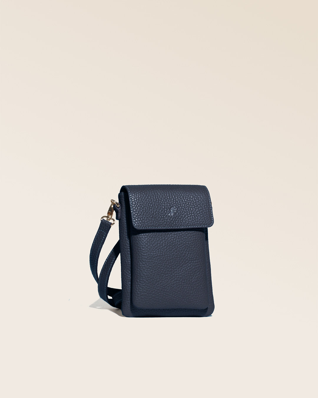 Our seagull clutch bag in navy blue vicuña-style leather, seen from the studio.
