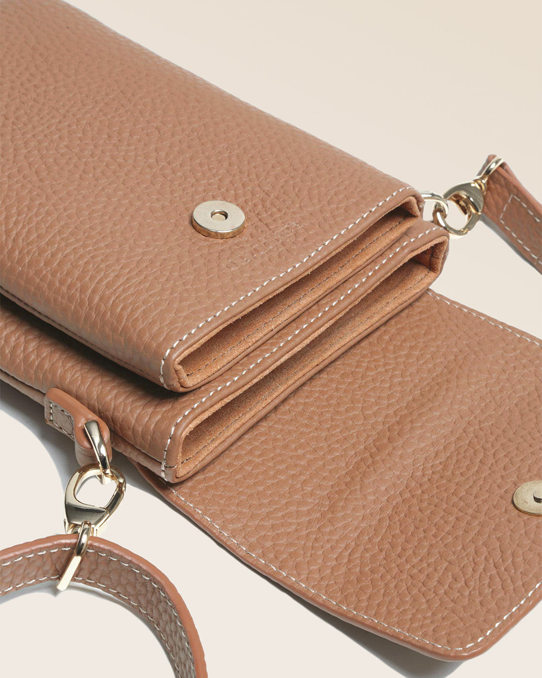 Our Gull clutch bag in fawn-colored vicuña leather, seen up close in the studio.