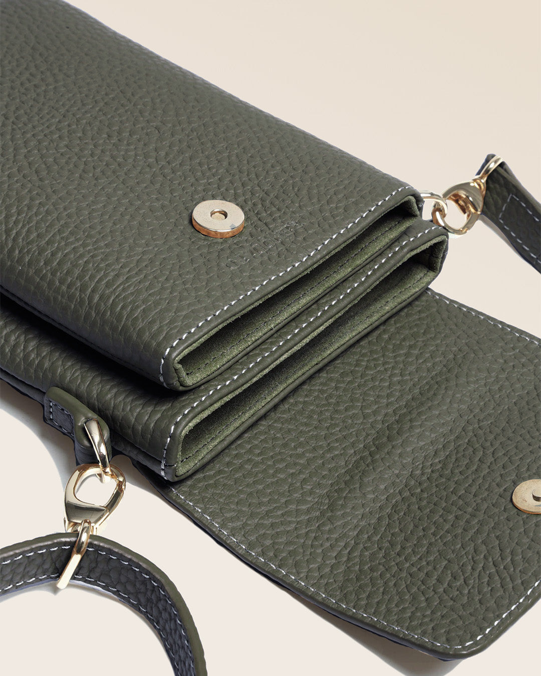 Our seagull clutch bag in khaki vicuña-style leather, seen up close in the studio.