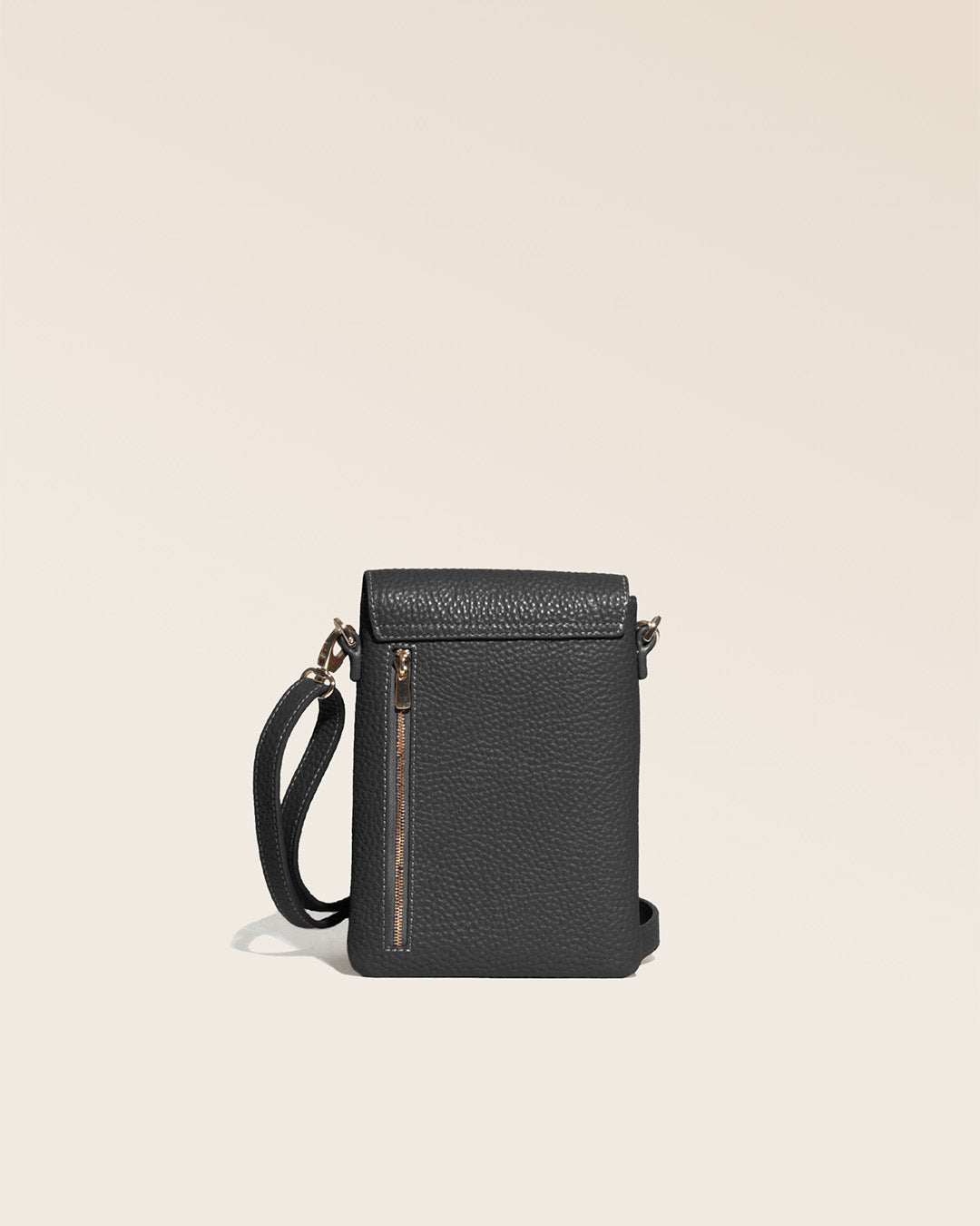 Our Gull clutch bag in black vicuña-style leather, seen from the back in the studio.