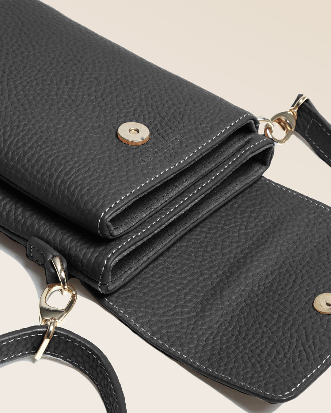 Our Gull clutch bag in black vicuña-style leather, seen up close in the studio.