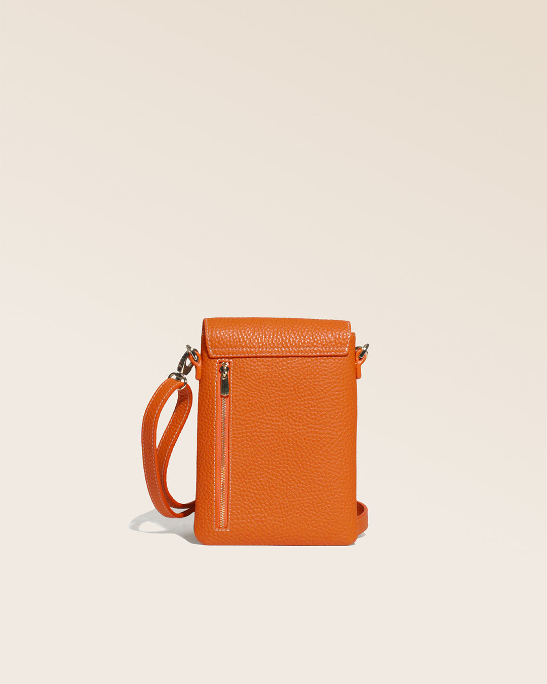 Our Gull clutch bag in orange vicuña-style leather, seen from the back in the studio.
