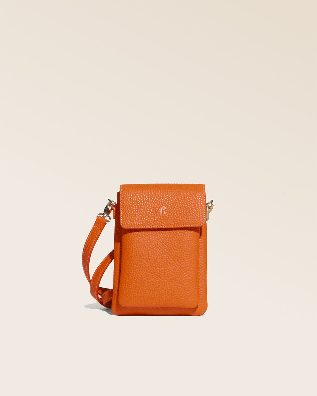 Our Gull clutch bag in orange vicuña-style leather, seen from the front in the studio.