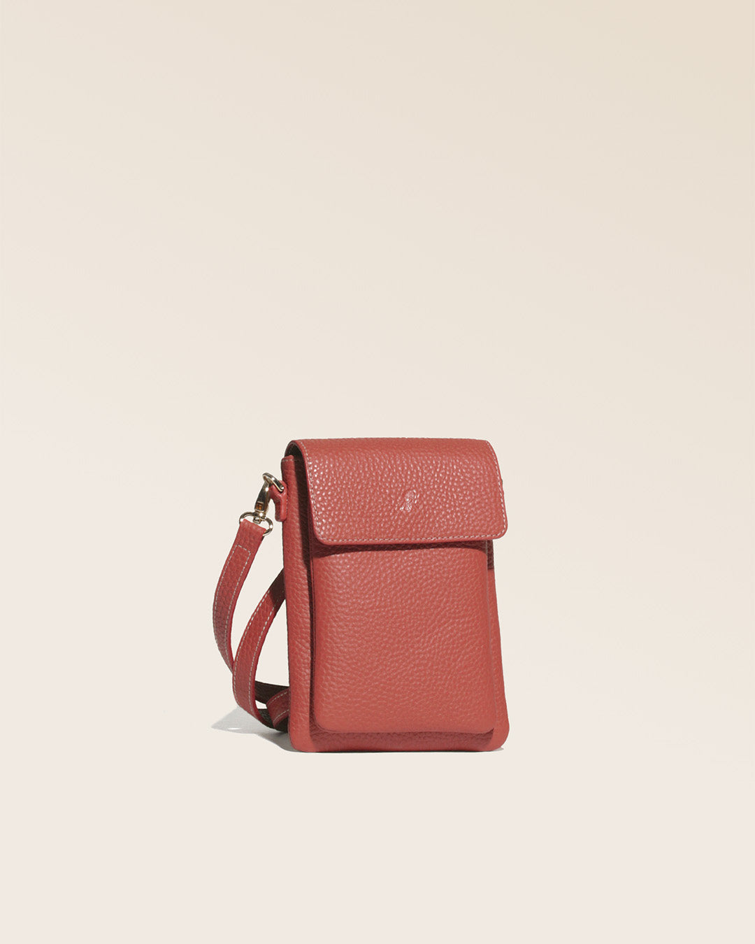 Our Renouard seagull clutch bag in terracotta vicuña-style leather, seen from the quarter in the studio.