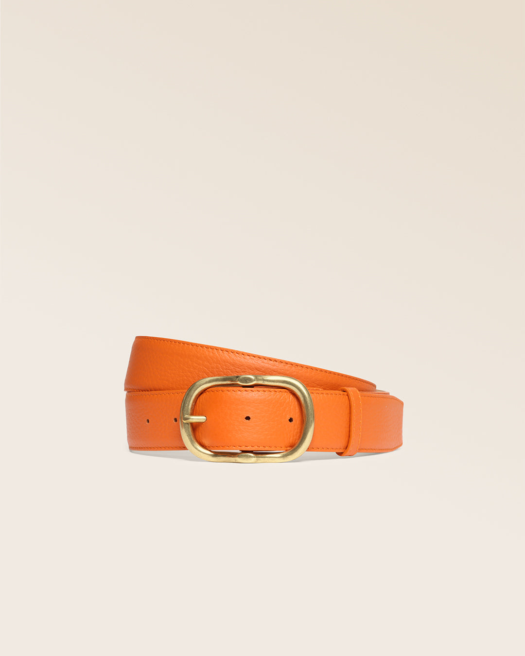 La ceinture Louison Renouard en cuir façon vigogne orange et sa boucle laiton vieilli, vue de face en studio.