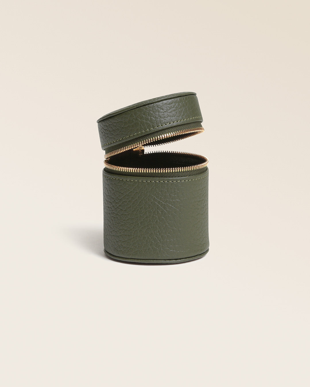 Our Renouard ring box in khaki vicuña-style leather, seen from the side, open in the studio.