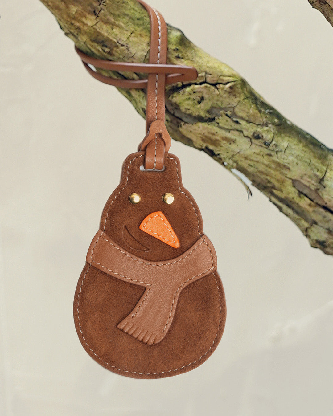 Le bijou de sac Bonhomme de Neige Renouard, en cuir veau velours noisette et cuir lisse camel, parfait pour accessoiriser votre sac ou cabas Renouard cet hiver ! 
