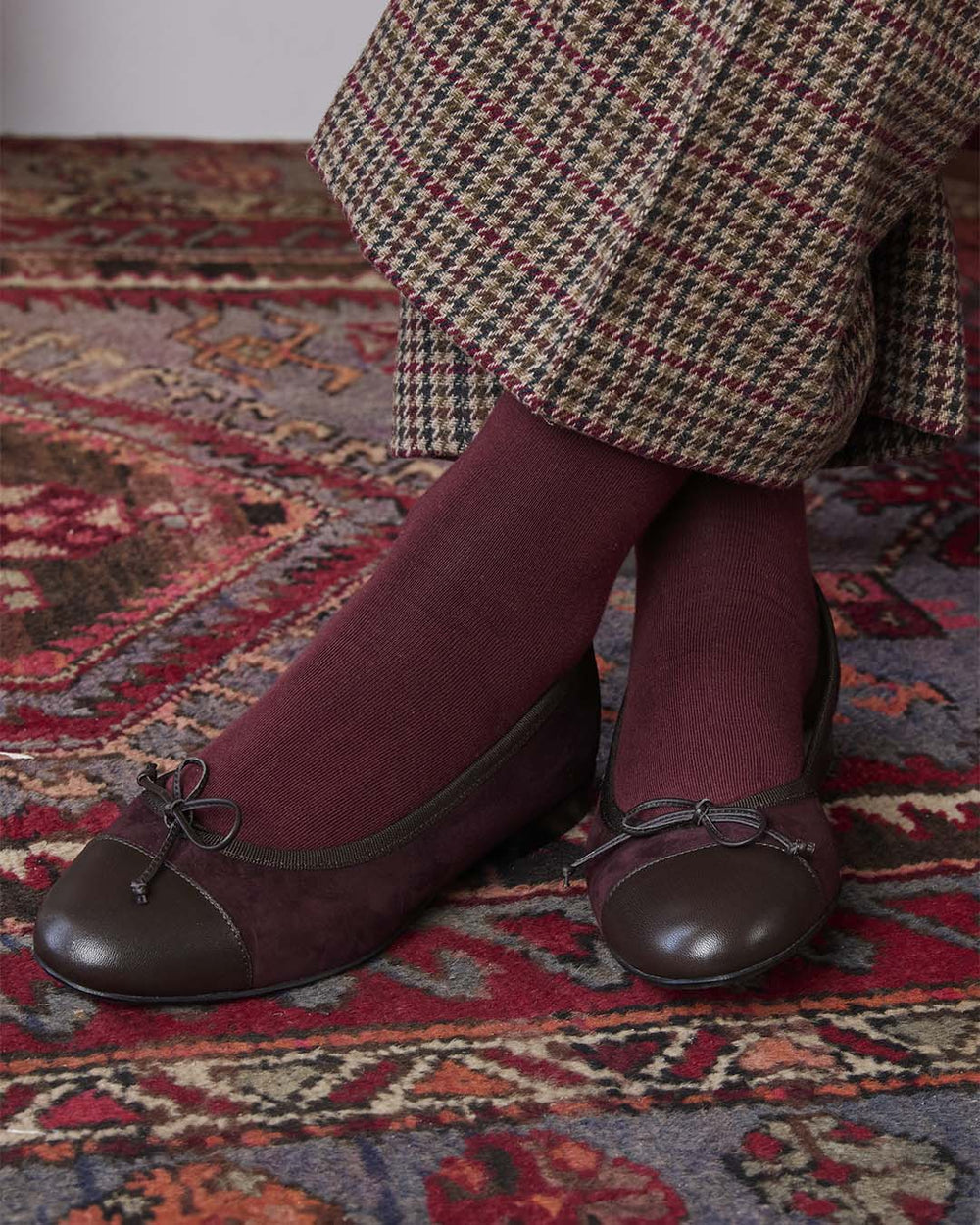 Our Friandise Renouard ballerinas in burgundy nubuck leather, seen worn by our model.