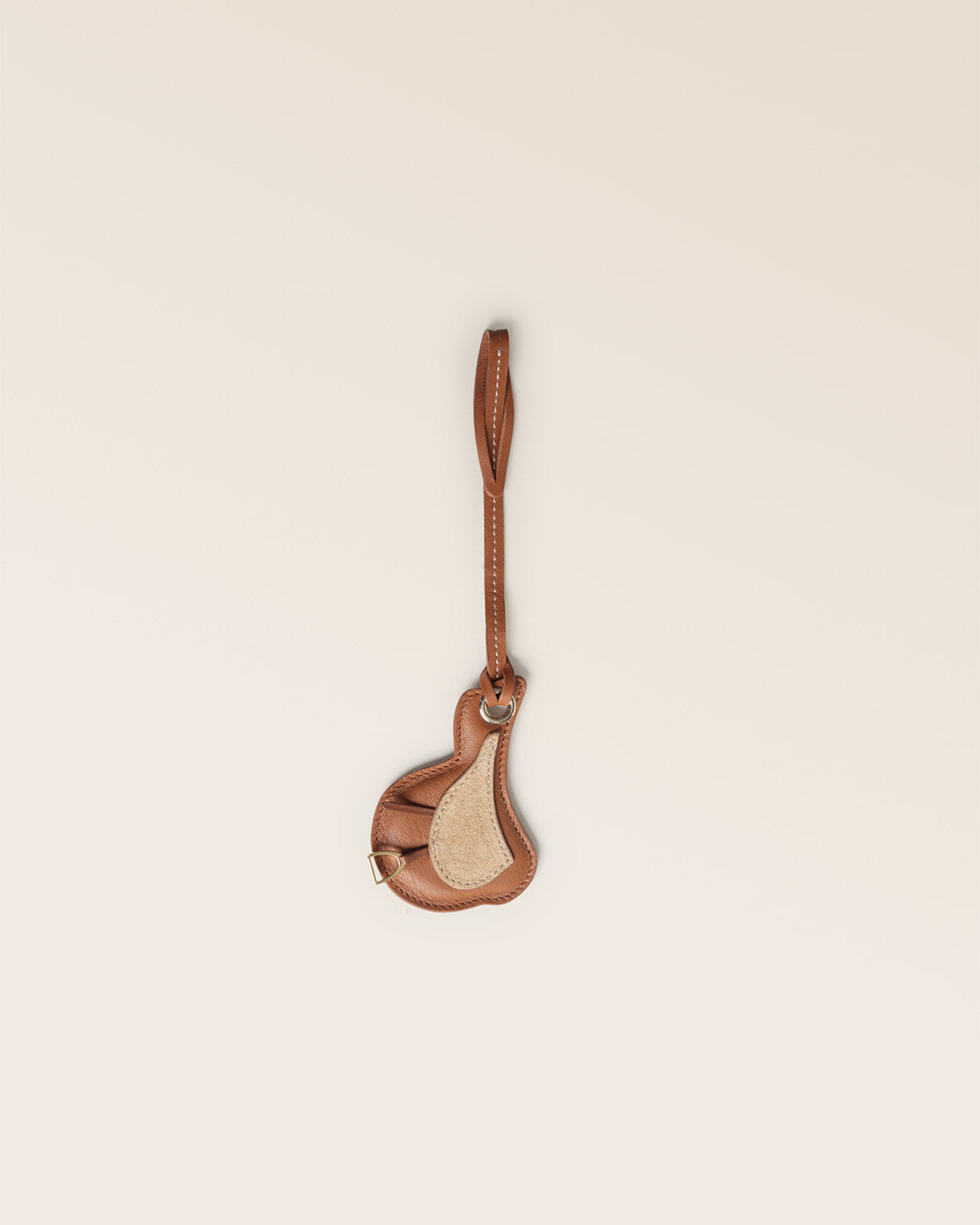 Notre bijou de sac Selle Renouard, en cuir vintage camel et veau velours sable, vu de face en studio.