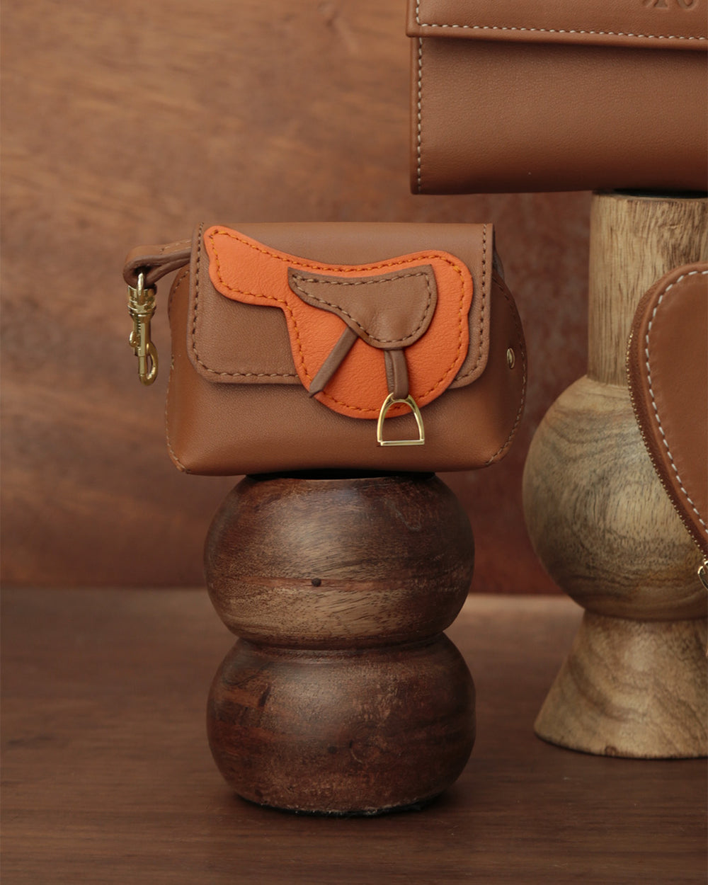 Notre étui Casaque Renouard en cuir vintage camel et façon vigogne orange, vu de face en ambiance.