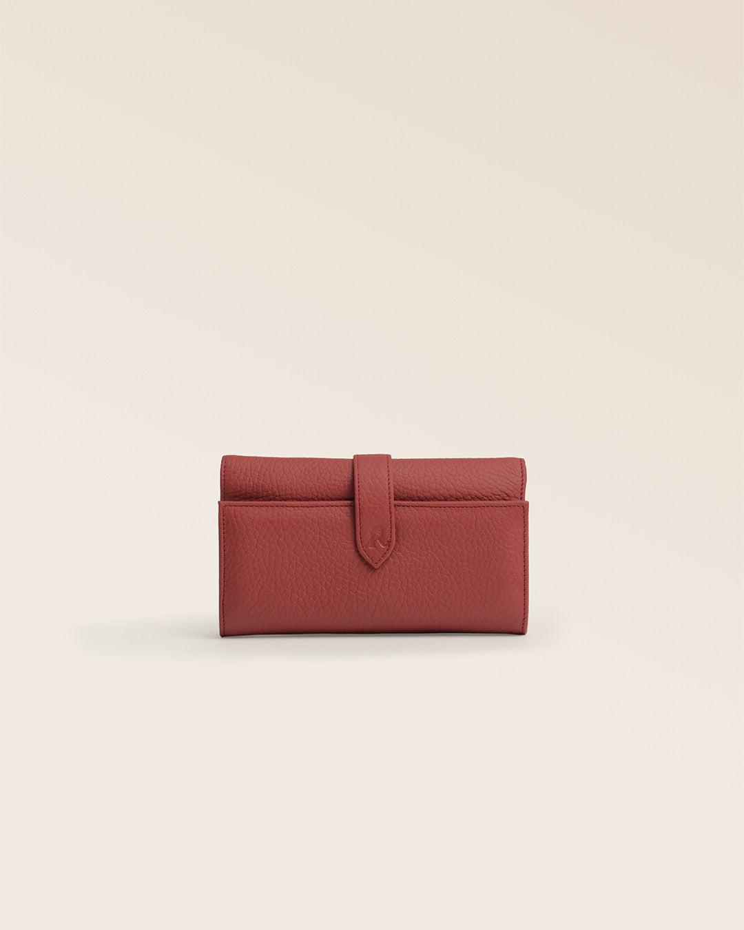 Notre porte-monnaie Adèle Renouard en cuir façon vigogne terracotta, vu de face en studio.