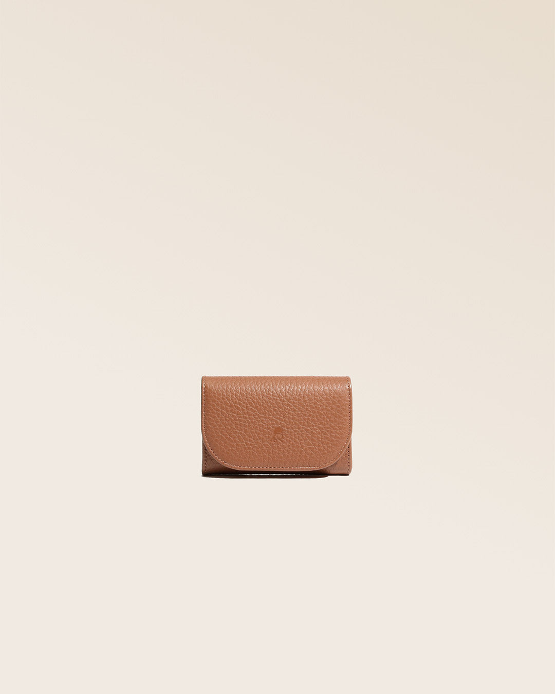 Our Alma wallet in fawn-colored vicuña leather, seen from the front in the studio.
