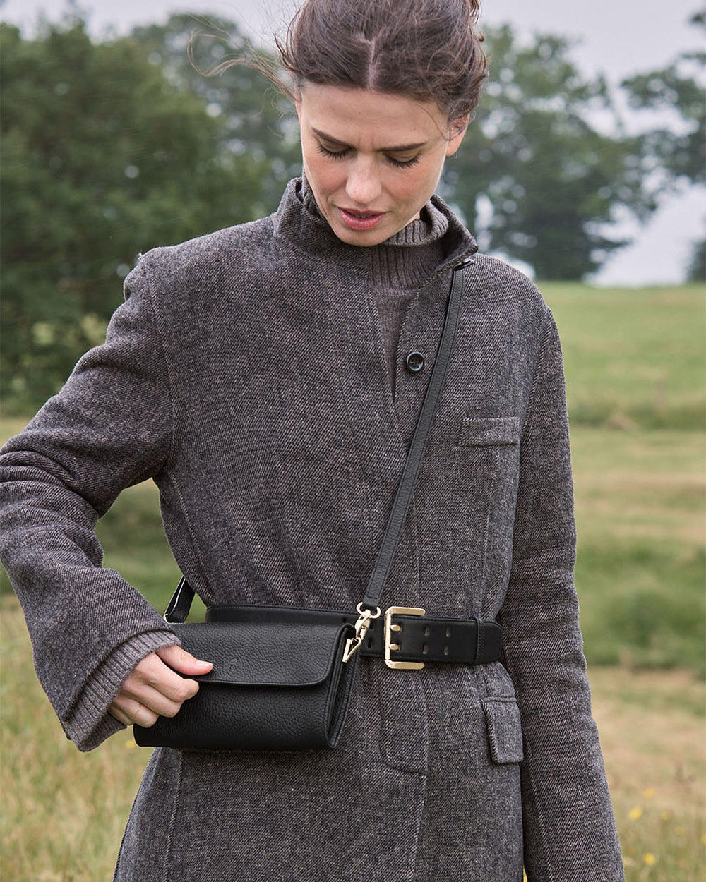 La pochette Raphaël Renouard en cuir façon vigogne noir vue portée par notre mannequin. 