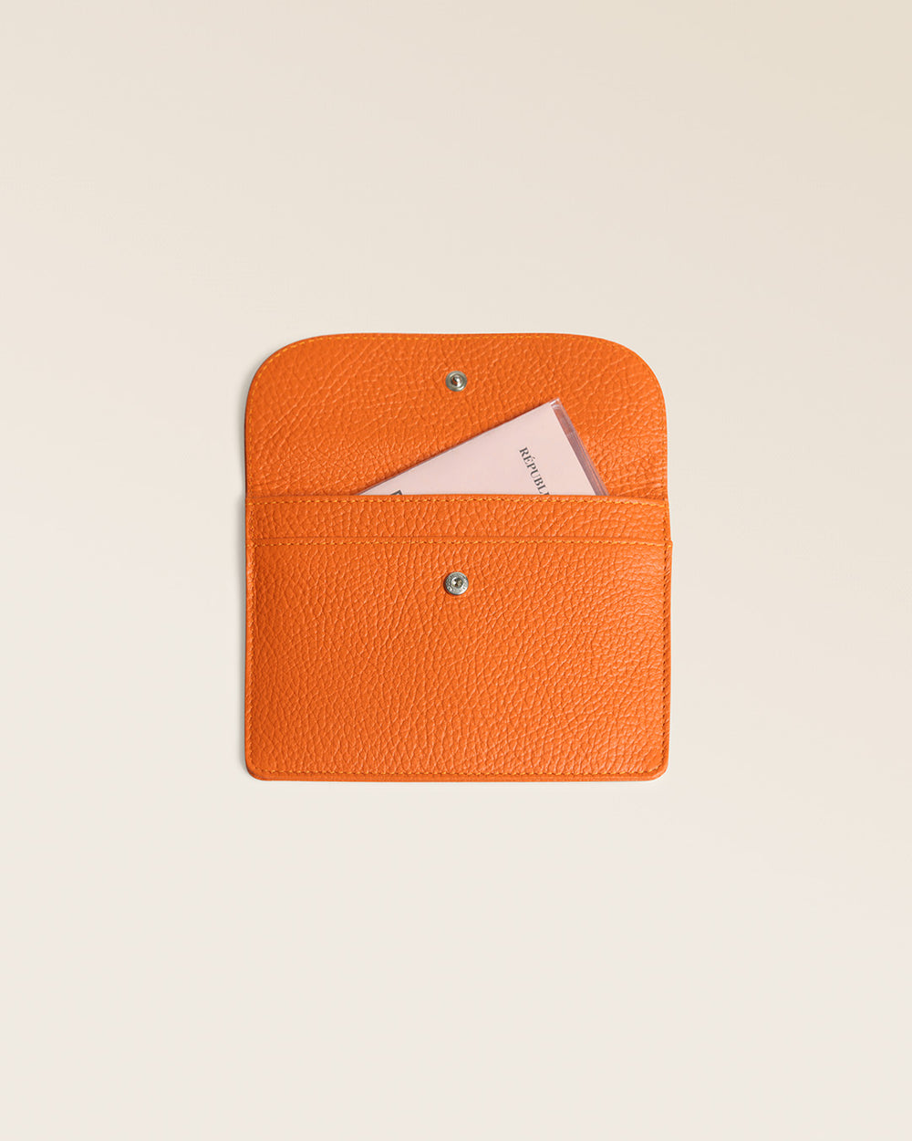 Our Aurore paperweight in orange vicuña-style leather seen open in the studio.