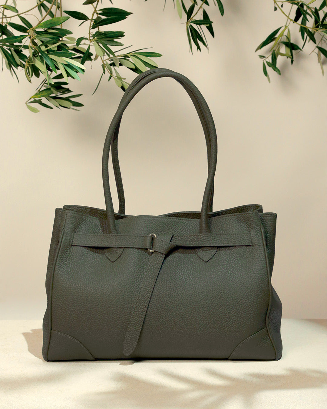 Notre sac Balneum Renouard en cuir façon vigogne kaki, vu de face en ambiance.