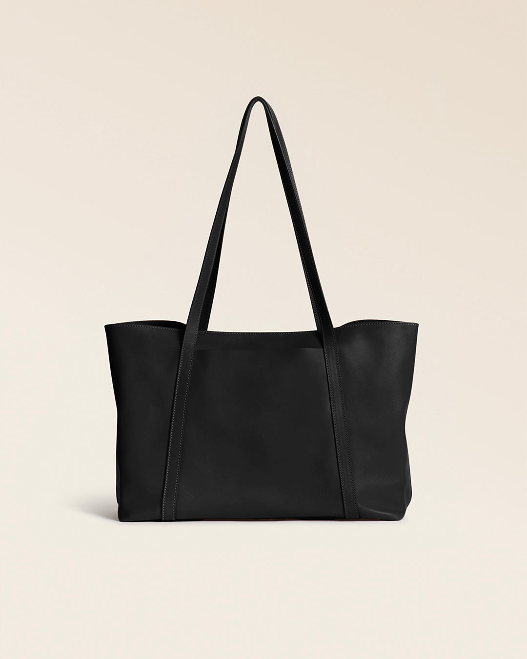 Notre cabas Annette Renouard en cuir lisse noir, vu de dos en studio.