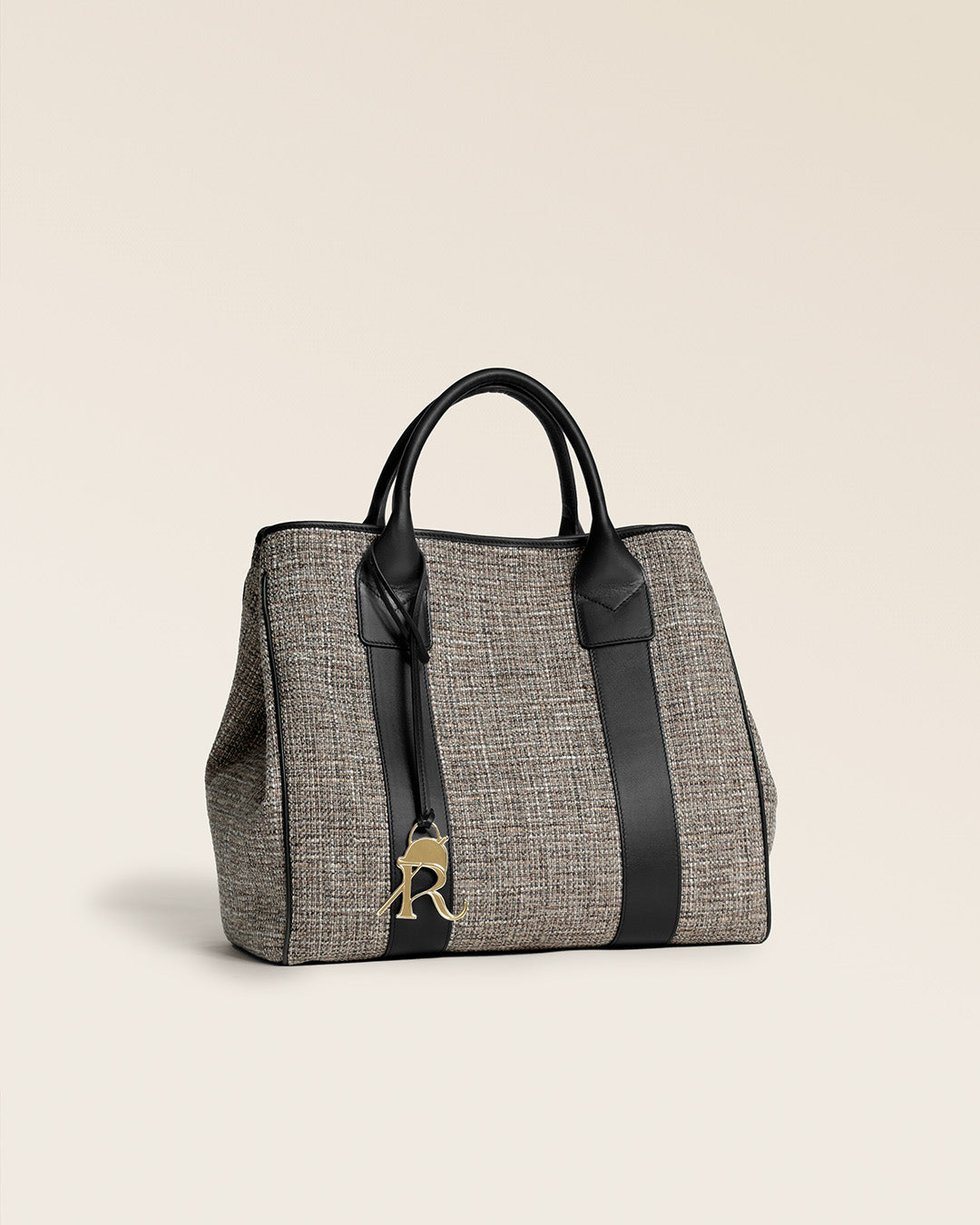 Le sac cabas Max Renouard en toile tweed taupe et cuir lisse noir, vu de quart en studio.