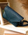 A front view of our Clothilde bag in smooth navy leather.