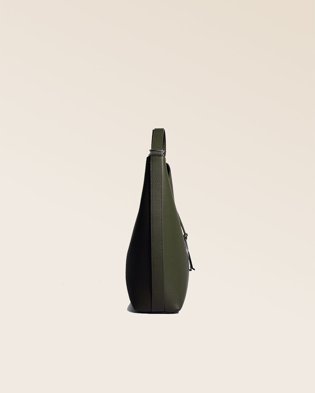 Our Cob Renouard bag, in its large version, in khaki vicuña-style leather, seen from the side in the studio.