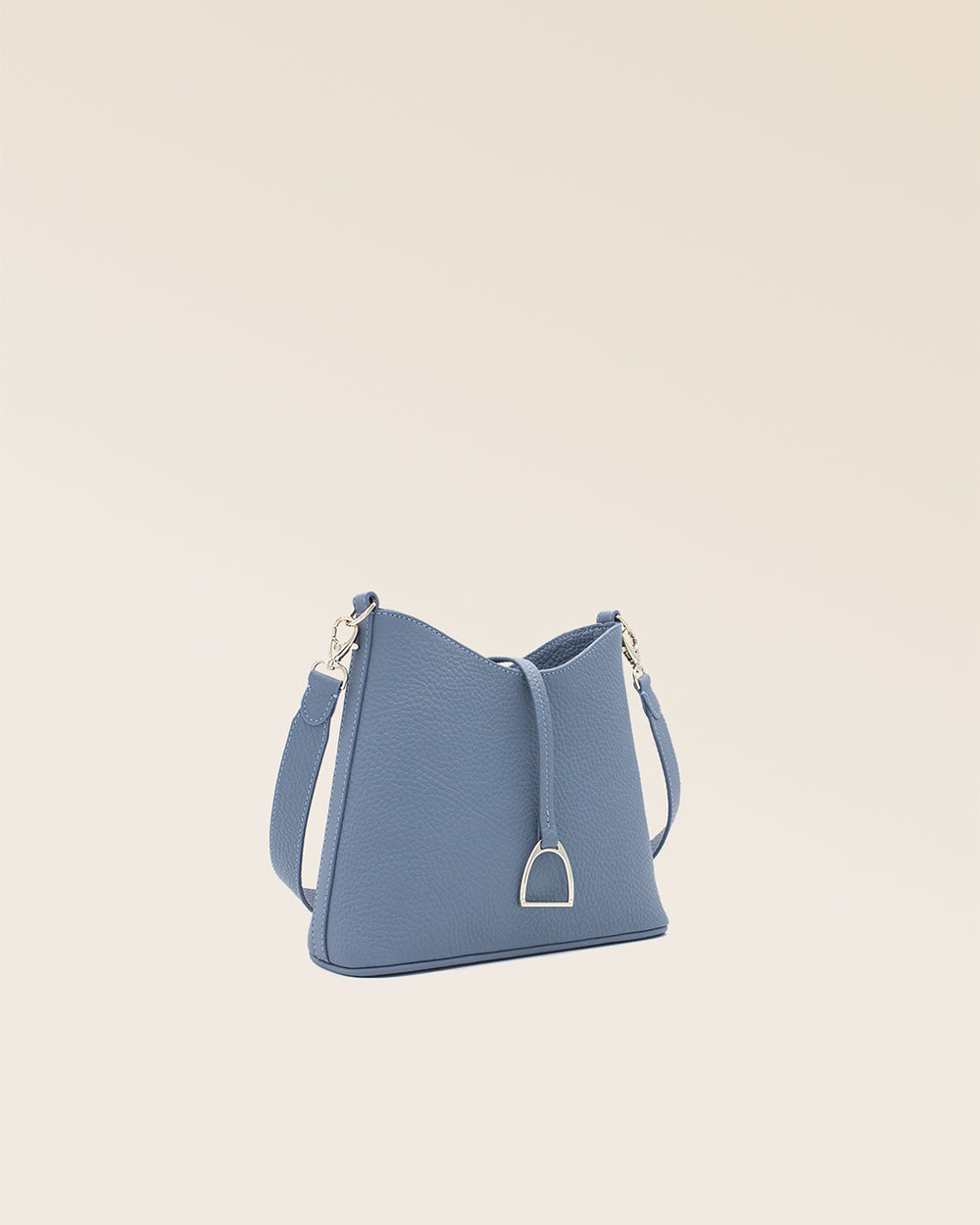 Notre sac Mini Cob en cuir façon vigogne bleu cobalt et bandoulière cuir, vu de quart en studio.