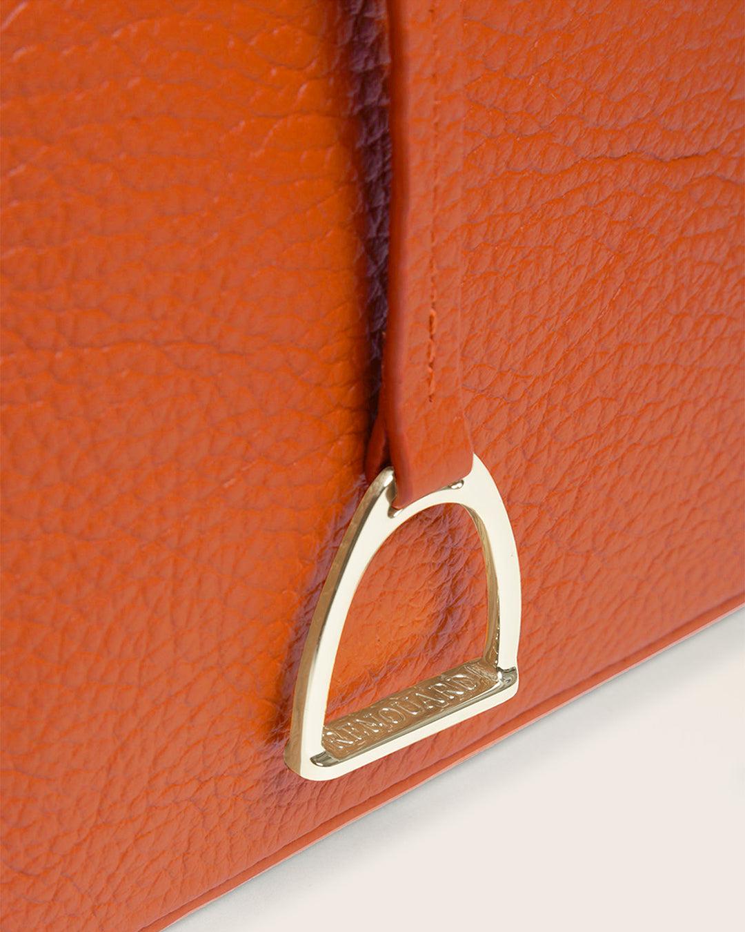 Our Cob Renouard bag in its Mini version, orange vicuña-style leather and leather shoulder strap; seen up close in the studio.