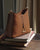 Notre sac Cob Renouard dans sa version Mini modèle, en cuir vintage camel et bandoulière cuir ; vu de quart en ambiance.