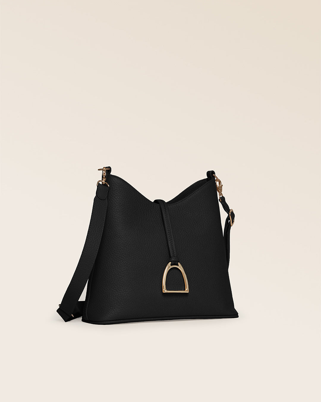 Notre sac Cob Renouard dans sa version Petit modèle, en cuir façon vigogne noir, accessoires dorés et bandoulière cuir ; vu de quart en studio.