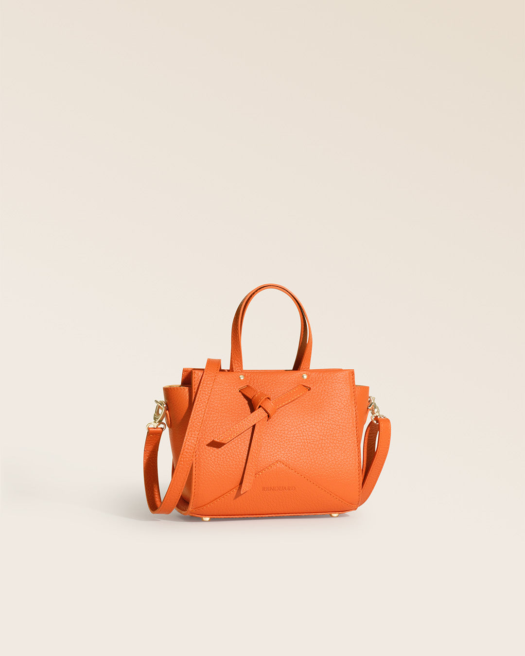 Our Renouard Croisière bag in orange vicuña-style leather, seen from the quarter in the studio.