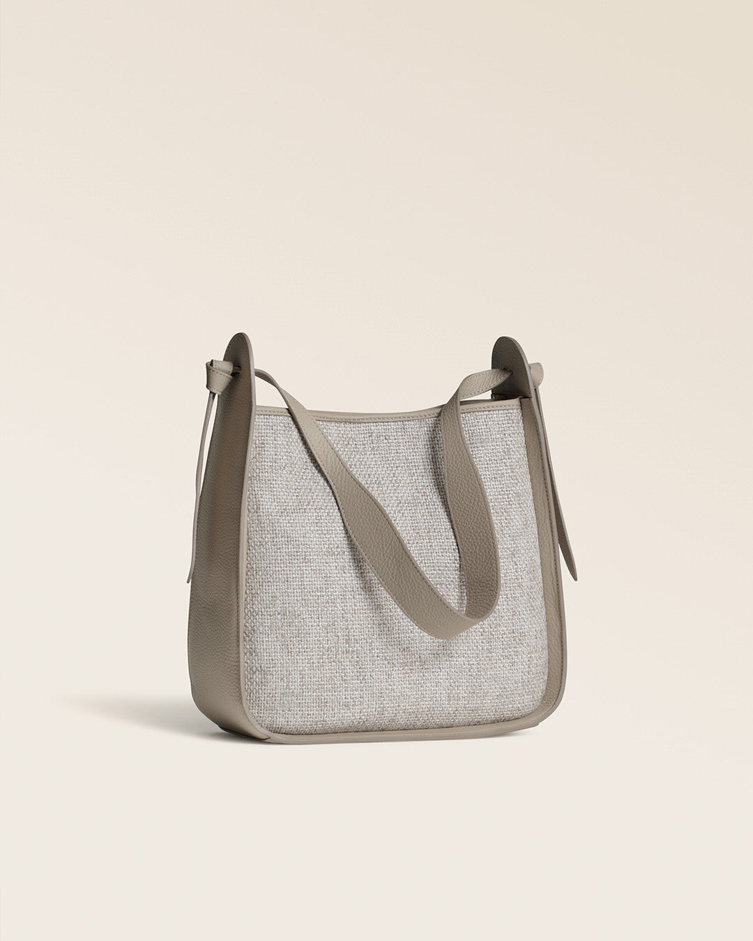 Notre sac Emilie Renouard en toile minérale et cuir façon vigogne corde, vu de quart en studio.