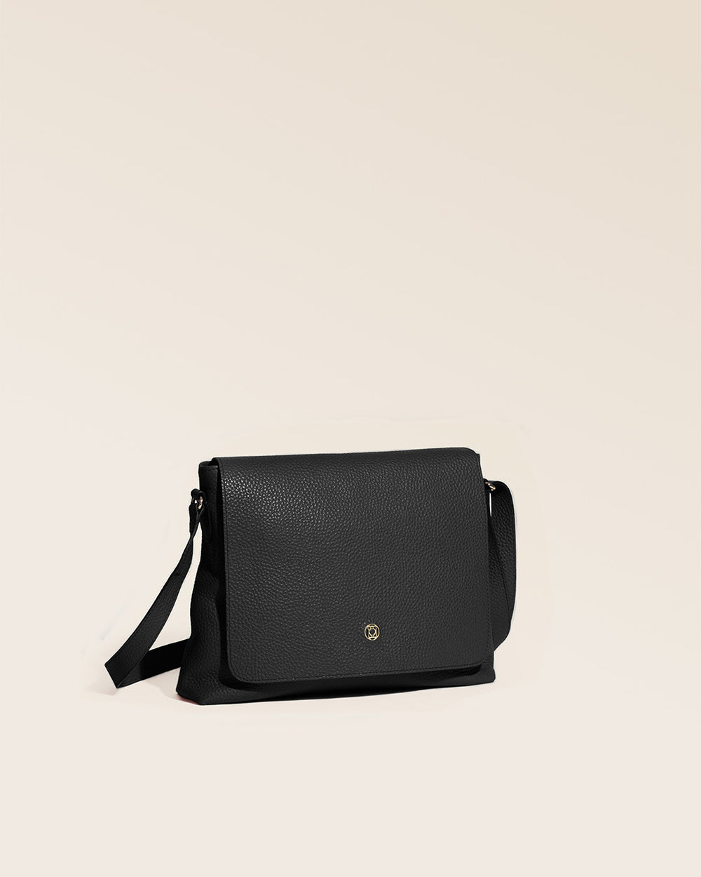 Our Gwenn bag in black vicuña-style leather, seen from the quarter in the studio.