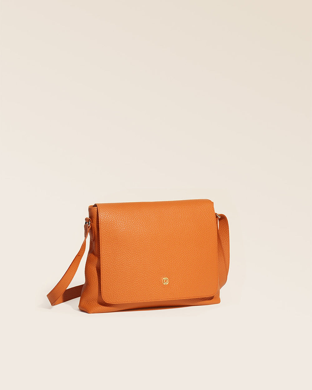 Our Gwenn bag in orange vicuña-style leather, seen from the quarter in the studio.