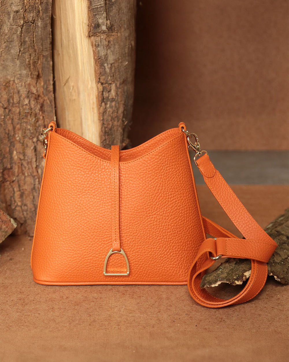Notre sac Cob Renouard dans sa version Mini modèle, cuir façon vigogne orange et bandoulière cuir ; vu de face en ambiance.