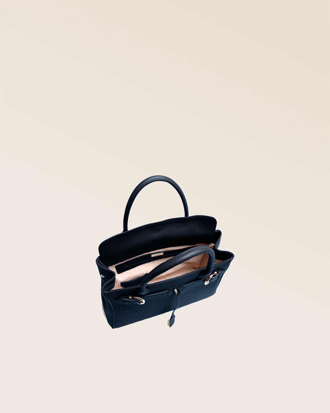Our Prestige Renouard bag, in its Mini version, in navy vicuña-style leather, seen from above in the studio.