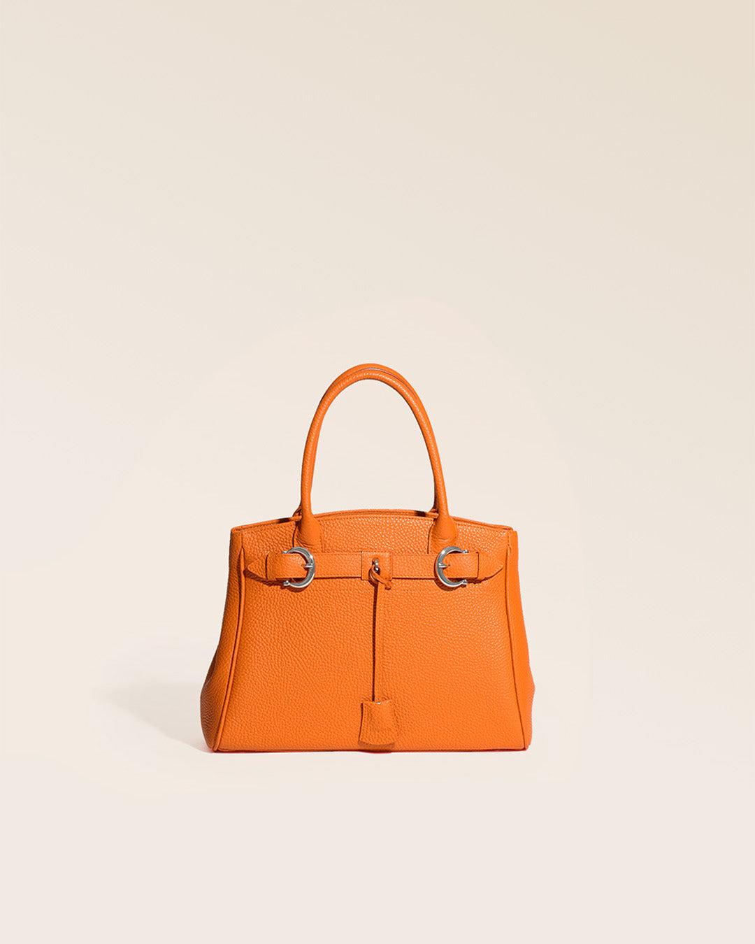 Our Prestige Renouard bag, in its Mini version, in orange vicuña-style leather, seen from the front in the studio.