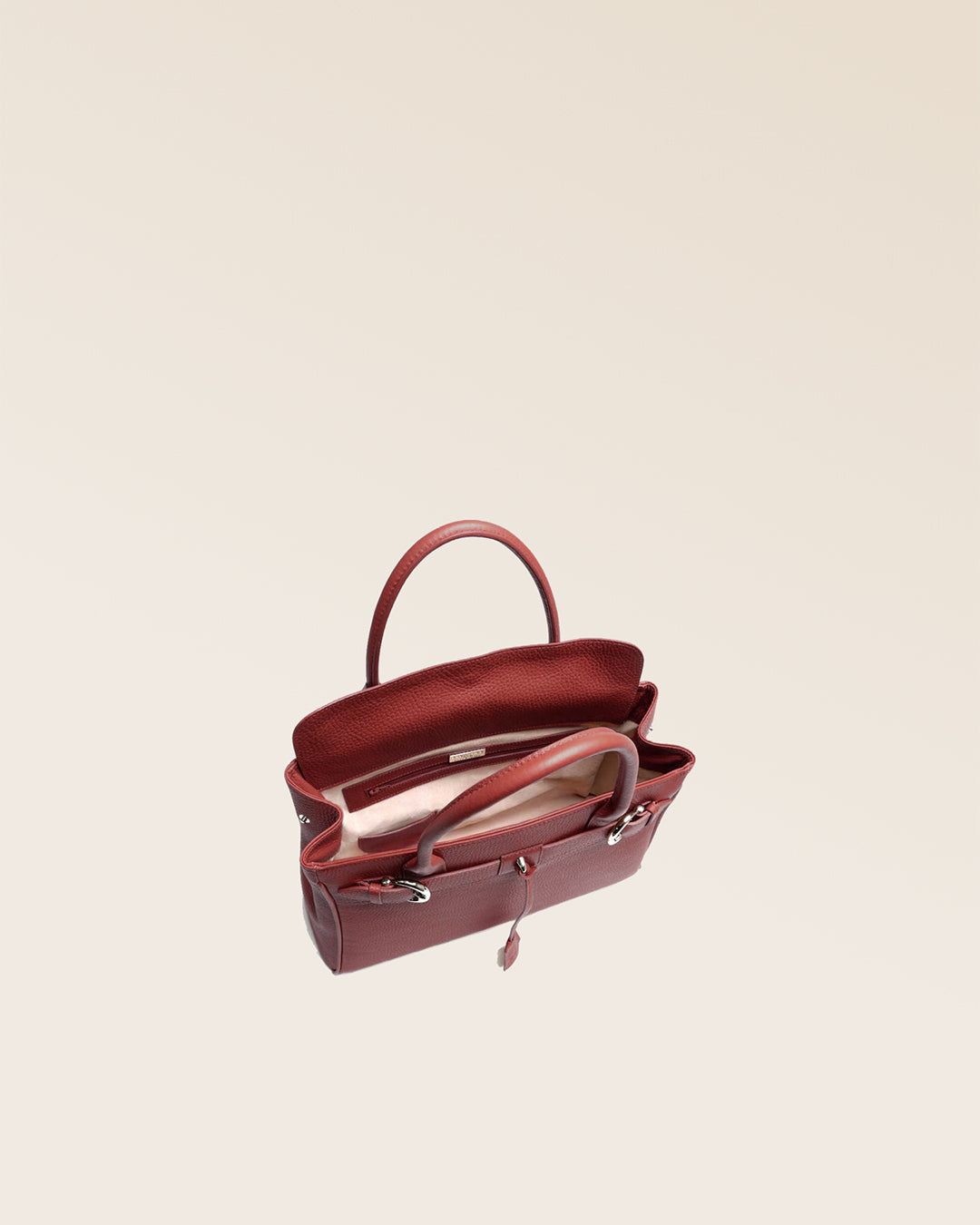 Our Prestige Renouard bag, in its Mini version, in terracotta vicuña-style leather, seen from above in the studio.