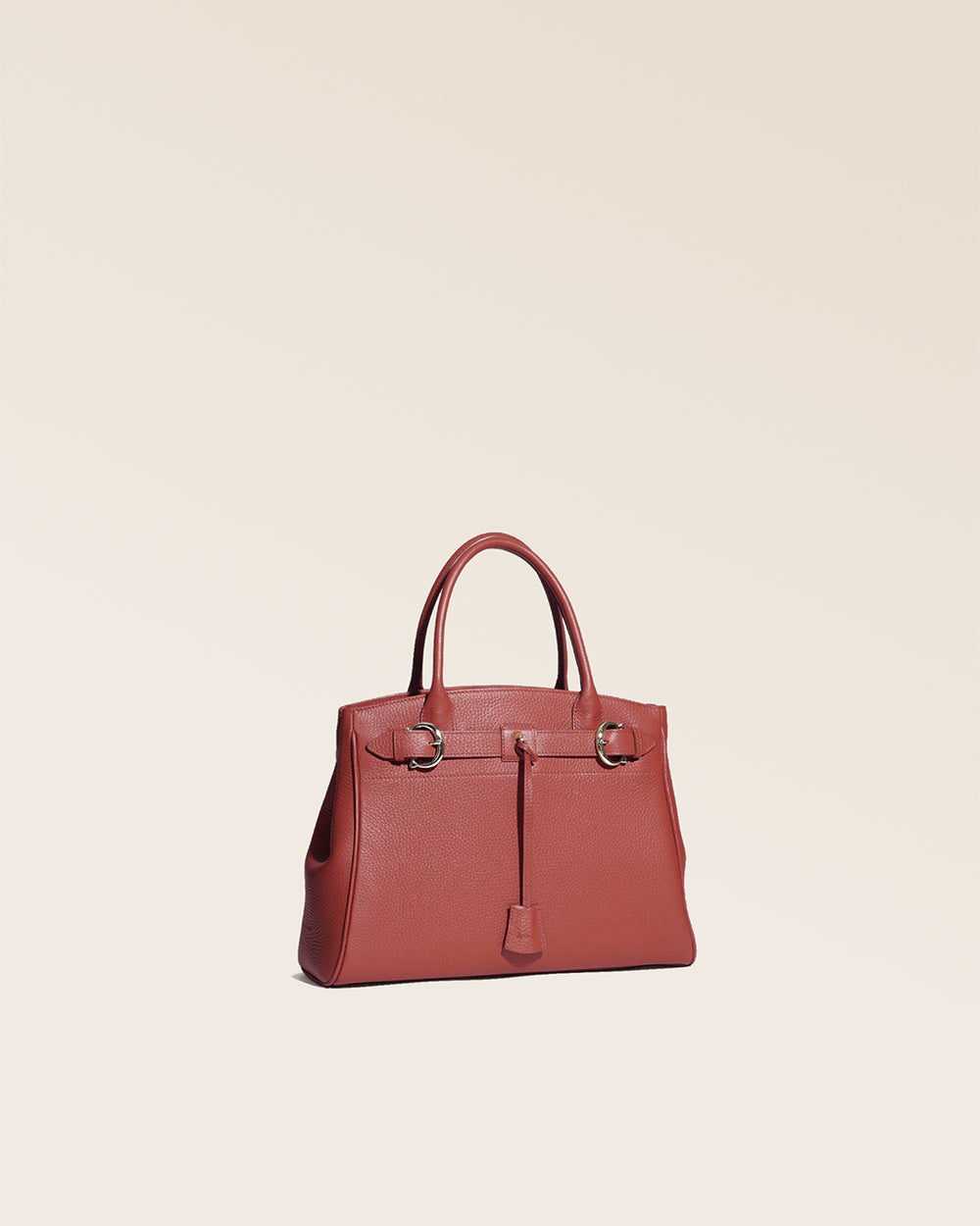 Our Prestige Renouard bag, in its Mini version, in terracotta vicuña-style leather, seen from the quarter in the studio.
