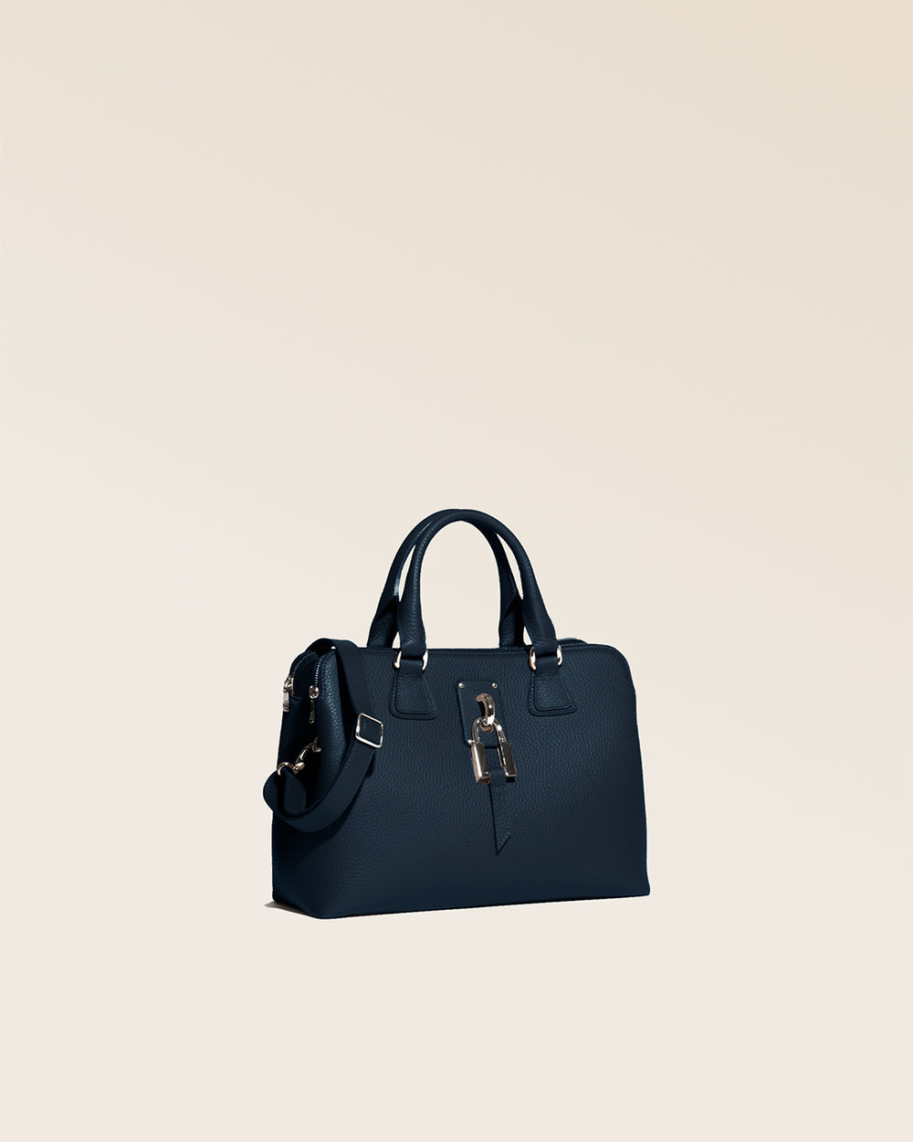 Our Renouard New-York bag, in its Mini version, with navy blue vicuña-style leather and gold accessories, seen from the quarter in the studio.