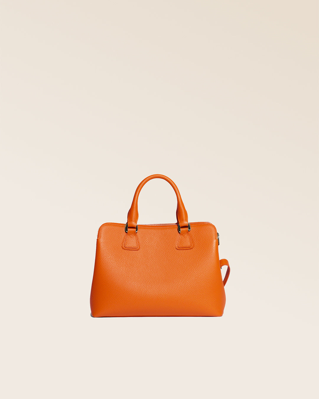 Our Renouard New-York bag, in its Mini version, in orange vicuña-style leather, seen from behind in the studio.