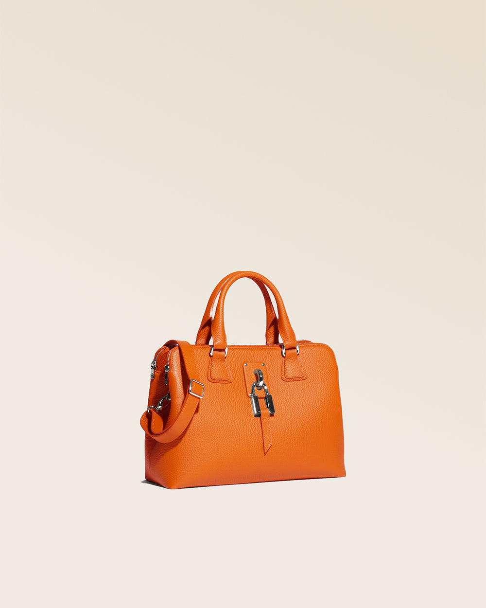 Our Renouard New-York bag, in its Mini version, in orange vicuña-style leather, seen from the quarter in the studio.