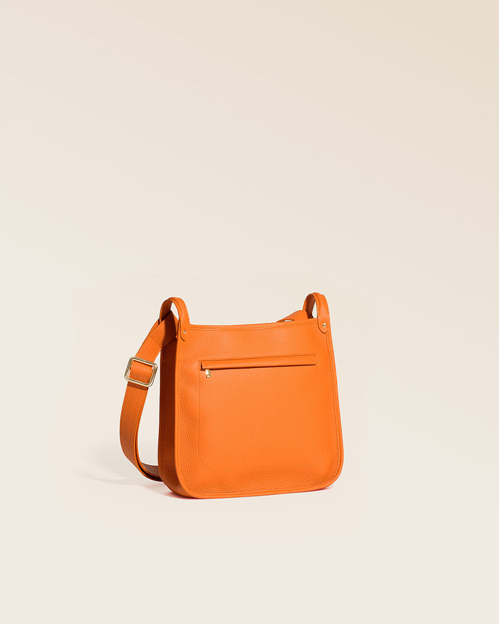Our Stan bag in orange vicuña-style leather, seen from the quarter in the studio.