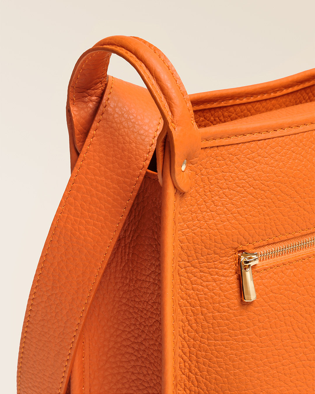 Our Stan bag in orange vicuña-style leather, seen up close in the studio.